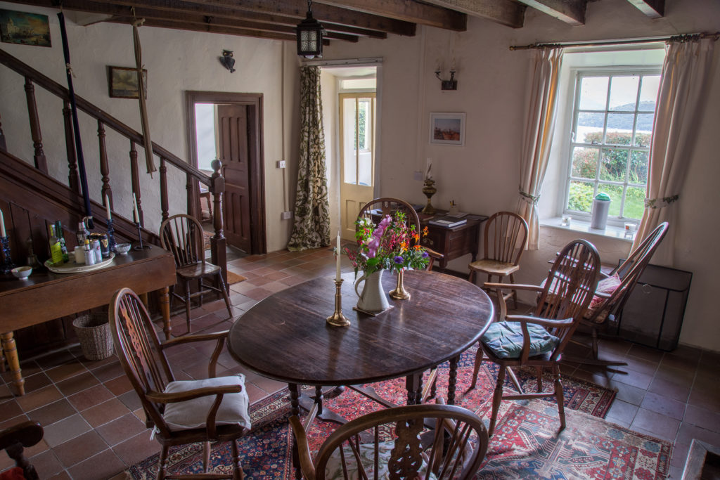 The dining hall, with its open fire, has many traditional farmhouse features. The room retains its nineteenth century wooden beams, along with its original fireplace and staircase. It is the ideal spot for candle lit winter dinners in front of a warm turf fire.